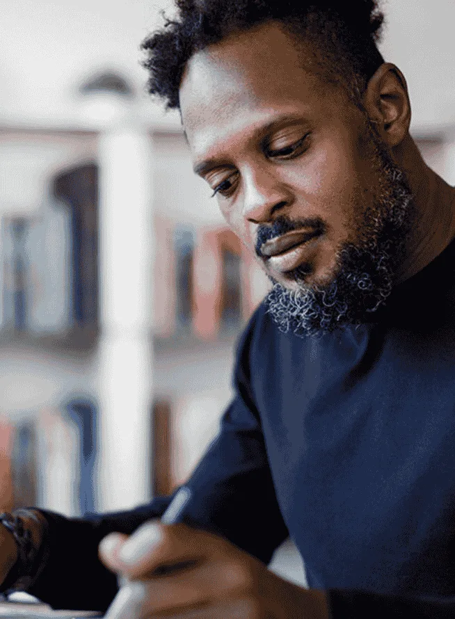 Man writing on a desk